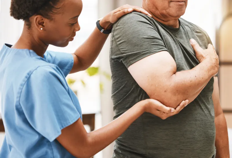 Chiropractor assisting patient with posture and alignment.